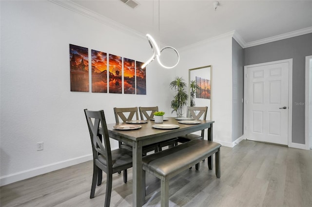 1375 Tuscana Ln Unit 1102, Davenport, FL 33896 - dining space with light wood finished floors, crown molding, and baseboards