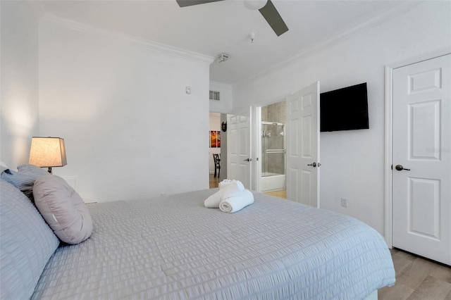 1375 Tuscana Ln Unit 1102, Davenport, FL 33896 - bedroom featuring ornamental molding, light wood-type flooring, ensuite bathroom, and a ceiling fan