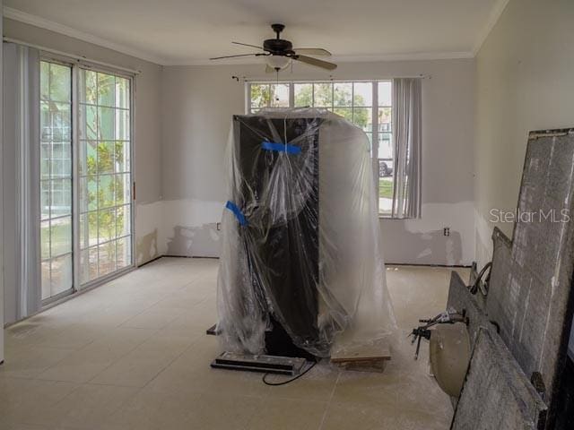 9584 Lake Chase Island Way Unit 958, Tampa, FL 33626 - empty room with healthy amount of natural light, crown molding, and ceiling fan
