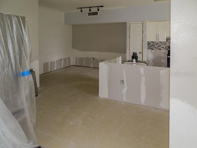 9584 Lake Chase Island Way Unit 958, Tampa, FL 33626 - full bath featuring rail lighting, backsplash, and ornamental molding