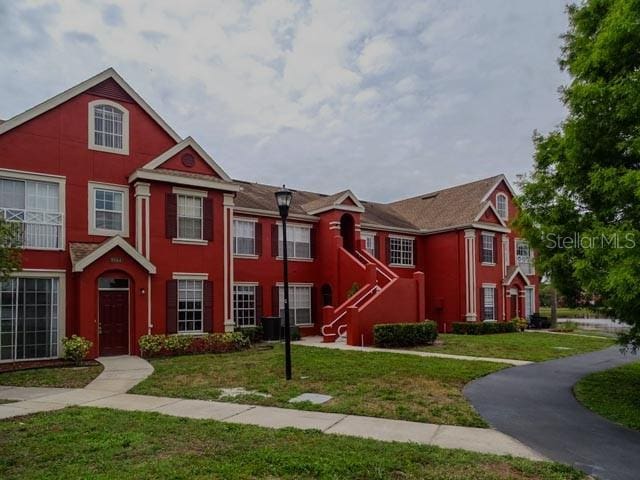 9584 Lake Chase Island Way Unit 958, Tampa, FL 33626 - view of front facade featuring a front lawn and stucco siding