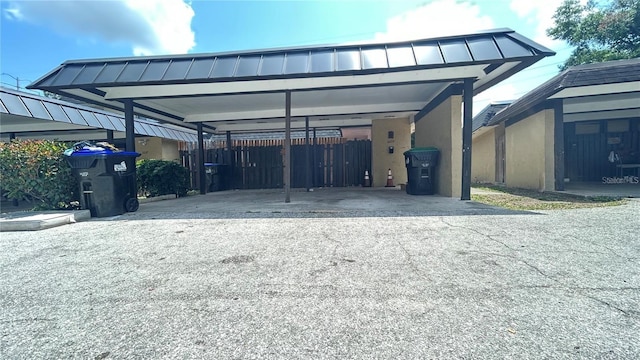 2235 Silver Pines Pl Unit 401, Orlando, FL 32808 - view of parking with asphalt driveway and a detached carport