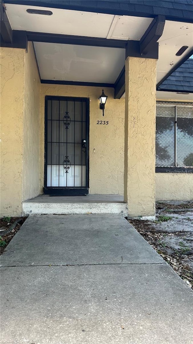2235 Silver Pines Pl Unit 401, Orlando, FL 32808 - doorway to property featuring stucco siding
