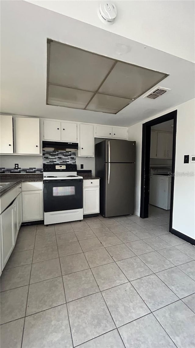 2235 Silver Pines Pl Unit 401, Orlando, FL 32808 - kitchen featuring freestanding refrigerator, electric range, dark countertops, white cabinetry, and light tile patterned floors