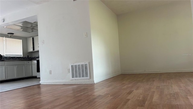 2235 Silver Pines Pl Unit 401, Orlando, FL 32808 - unfurnished living room with wood finished floors and baseboards
