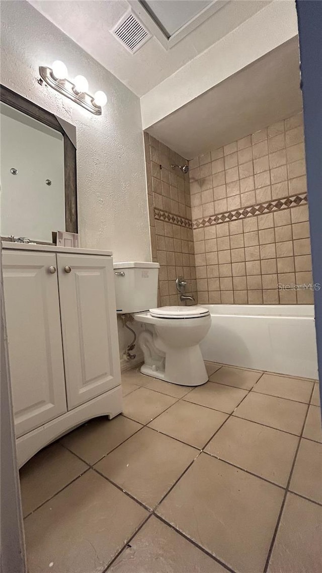 2235 Silver Pines Pl Unit 401, Orlando, FL 32808 - full bathroom featuring a textured wall, toilet, tile patterned flooring, shower / bathtub combination, and vanity