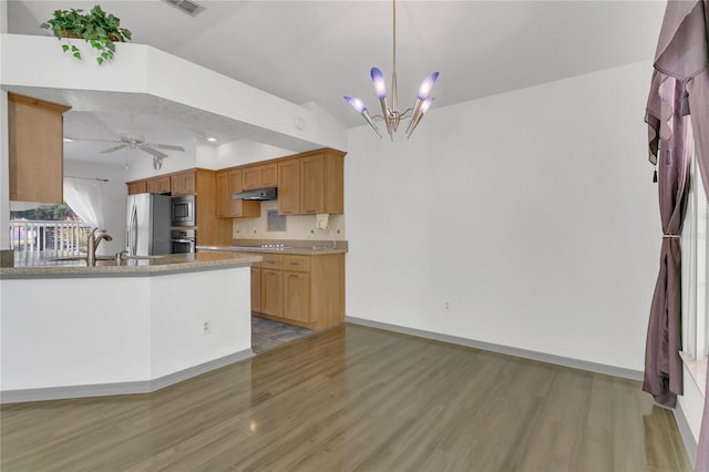 485 Whittingham Pl, Lake Mary, FL 32746 - kitchen with appliances with stainless steel finishes, under cabinet range hood, light wood-style floors, vaulted ceiling, and a chandelier