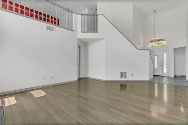 485 Whittingham Pl, Lake Mary, FL 32746 - unfurnished living room featuring a towering ceiling and wood finished floors