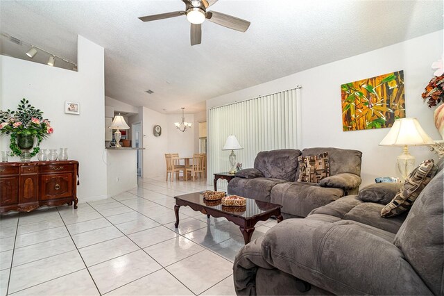 11512 Clair Pl, Clermont, FL 34711 - living area featuring vaulted ceiling, ceiling fan, a chandelier, light tile patterned flooring, and a textured ceiling