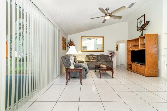 11512 Clair Pl, Clermont, FL 34711 - living room with lofted ceiling, arched walkways, ceiling fan, and light tile patterned flooring