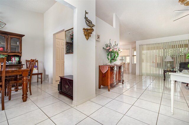 11512 Clair Pl, Clermont, FL 34711 - hallway featuring light tile patterned floors, high vaulted ceiling, and a textured ceiling