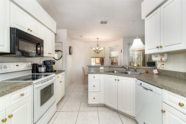 11512 Clair Pl, Clermont, FL 34711 - kitchen with white appliances, a sink, a chandelier, a peninsula, and white cabinetry