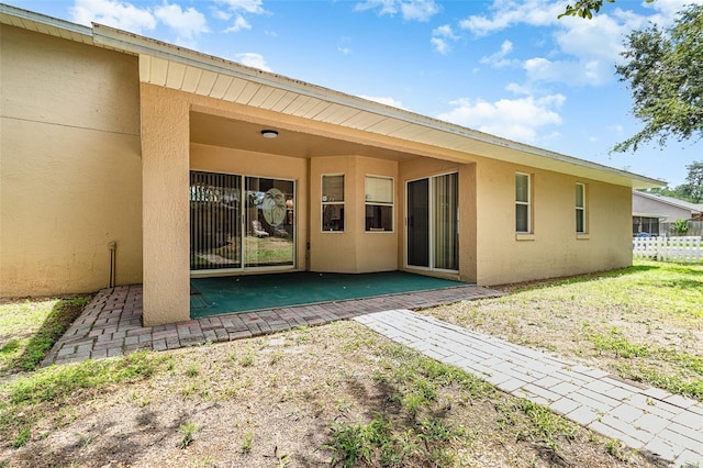 11512 Clair Pl, Clermont, FL 34711 - rear view of house with stucco siding and a patio