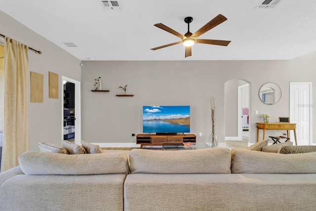 1913 Lazy Oaks Loop, Saint Cloud, FL 34771 - living area with arched walkways, a ceiling fan, and baseboards