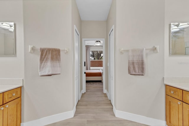1913 Lazy Oaks Loop, Saint Cloud, FL 34771 - ensuite bathroom with vanity, baseboards, wood finished floors, and a ceiling fan