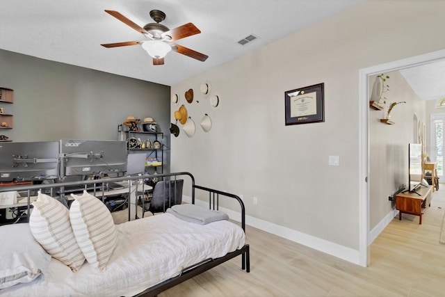 1913 Lazy Oaks Loop, Saint Cloud, FL 34771 - bedroom with wood finished floors, a ceiling fan, and baseboards