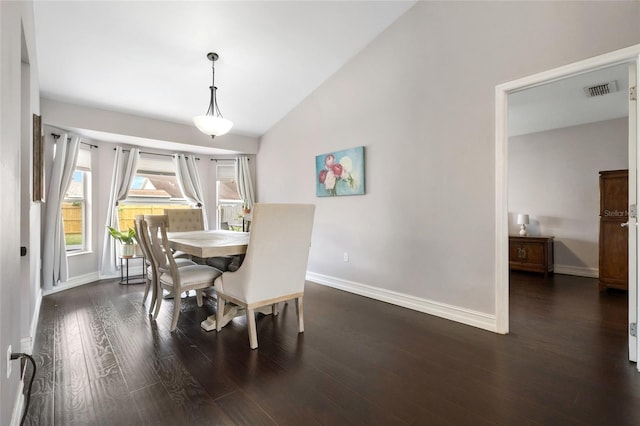 1616 Golden Poppy Ct, Orlando, FL 32824 - dining space featuring baseboards, dark wood-style flooring, and vaulted ceiling