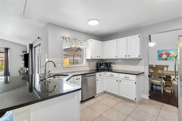1616 Golden Poppy Ct, Orlando, FL 32824 - kitchen featuring appliances with stainless steel finishes, a sink, decorative backsplash, and white cabinets
