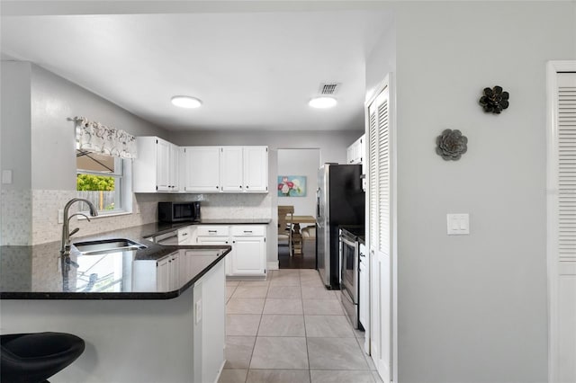 1616 Golden Poppy Ct, Orlando, FL 32824 - kitchen featuring a sink, appliances with stainless steel finishes, a peninsula, and tasteful backsplash