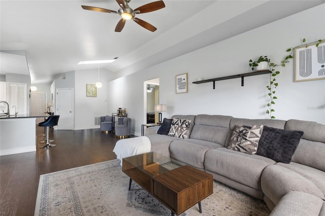 1616 Golden Poppy Ct, Orlando, FL 32824 - living room with ceiling fan, vaulted ceiling, dark wood finished floors, and baseboards