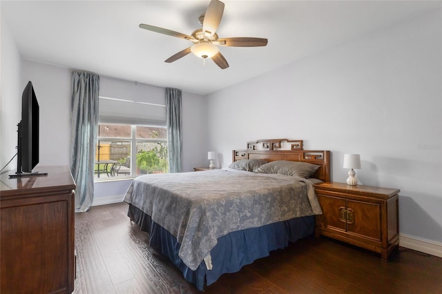1616 Golden Poppy Ct, Orlando, FL 32824 - bedroom with dark wood finished floors, baseboards, and a ceiling fan