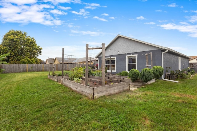 1616 Golden Poppy Ct, Orlando, FL 32824 - rear view of property with a vegetable garden and stucco siding