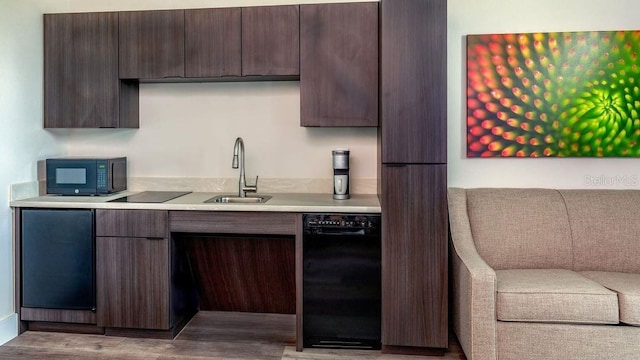 15695 Grove Resort Ave Unit 4235, Winter Garden, FL 34787 - kitchen with black appliances, dark brown cabinetry, light countertops, wood finished floors, and modern cabinets