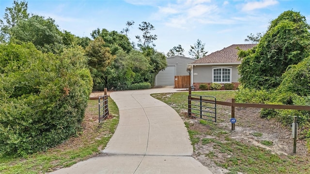 41128 Apple St, Eustis, FL 32736 - view of front facade featuring driveway, a gate, a garage, stucco siding, and brick siding