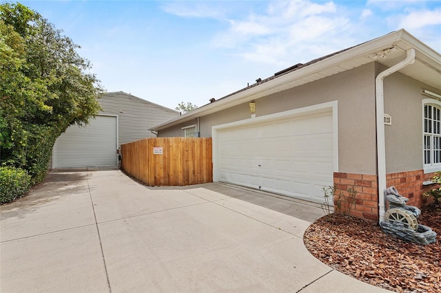 41128 Apple St, Eustis, FL 32736 - view of home's exterior with stucco siding, concrete driveway, and a garage