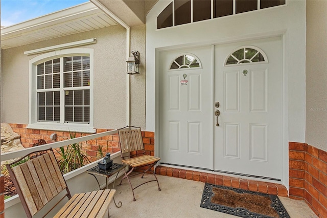 41128 Apple St, Eustis, FL 32736 - view of exterior entry featuring stucco siding and a porch