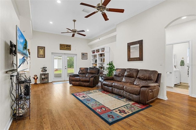 41128 Apple St, Eustis, FL 32736 - living area with ceiling fan, wood finished floors, recessed lighting, arched walkways, and french doors