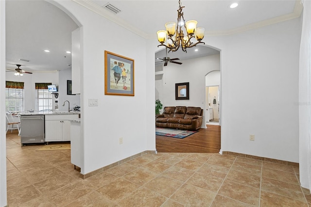 41128 Apple St, Eustis, FL 32736 - hallway featuring recessed lighting, arched walkways, crown molding, a chandelier, and a sink