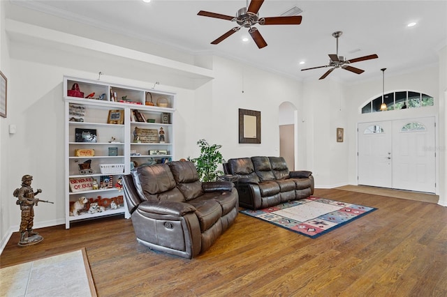 41128 Apple St, Eustis, FL 32736 - living area with arched walkways, ceiling fan, wood finished floors, recessed lighting, and ornamental molding
