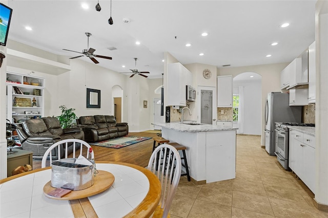 41128 Apple St, Eustis, FL 32736 - dining area with arched walkways, a ceiling fan, recessed lighting, and light tile patterned floors