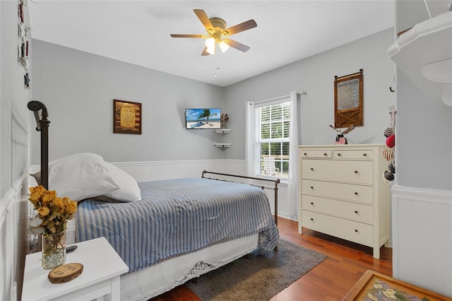 41128 Apple St, Eustis, FL 32736 - bedroom with wainscoting, wood finished floors, and a ceiling fan