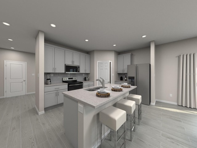 1740 Brekey Way, Zephyrhills, FL 33541 - kitchen with stainless steel appliances, a sink, gray cabinets, light wood-style flooring, and recessed lighting
