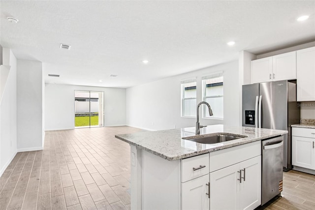 1740 Brekey Way, Zephyrhills, FL 33541 - kitchen featuring dishwasher, plenty of natural light, light wood-style flooring, a center island with sink, and recessed lighting
