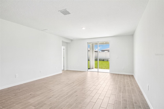 1740 Brekey Way, Zephyrhills, FL 33541 - unfurnished room featuring light wood finished floors and a textured ceiling