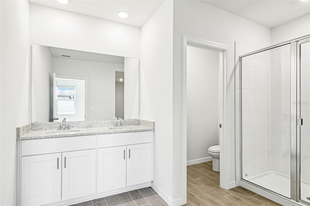 1740 Brekey Way, Zephyrhills, FL 33541 - full bathroom with double vanity, a stall shower, wood tiled floors, and recessed lighting