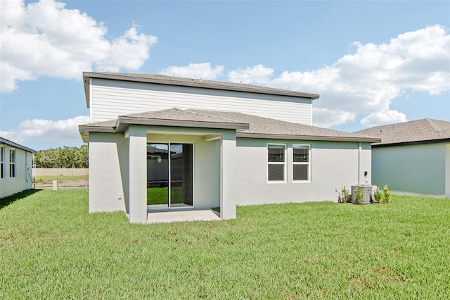 1740 Brekey Way, Zephyrhills, FL 33541 - rear view of property with a yard, a shingled roof, and stucco siding