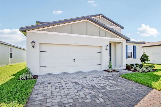 1740 Brekey Way, Zephyrhills, FL 33541 - view of front facade with board and batten siding, decorative driveway, a garage, and a front lawn