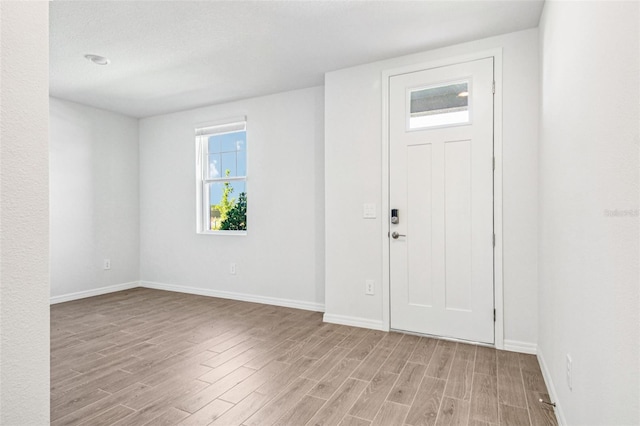 1740 Brekey Way, Zephyrhills, FL 33541 - foyer with light wood-style flooring and baseboards
