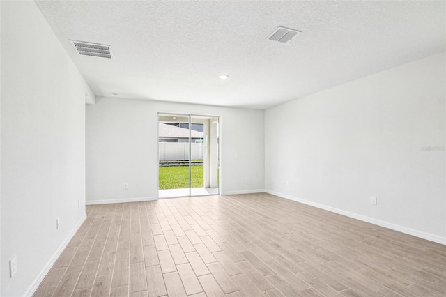 1740 Brekey Way, Zephyrhills, FL 33541 - empty room featuring wood finished floors and a textured ceiling