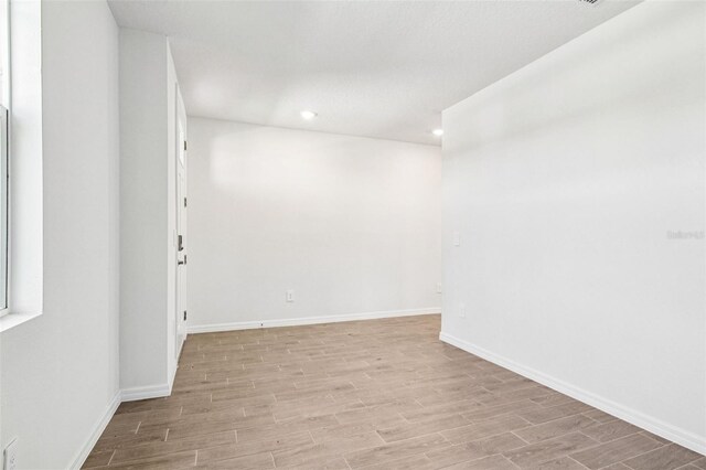 1740 Brekey Way, Zephyrhills, FL 33541 - unfurnished room featuring light wood finished floors and recessed lighting