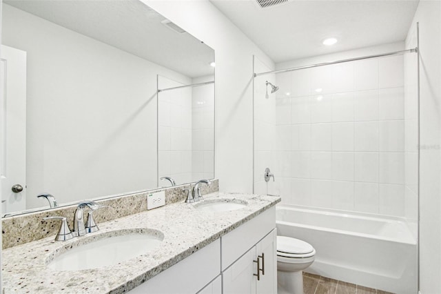 1740 Brekey Way, Zephyrhills, FL 33541 - bathroom featuring double vanity, washtub / shower combination, and recessed lighting