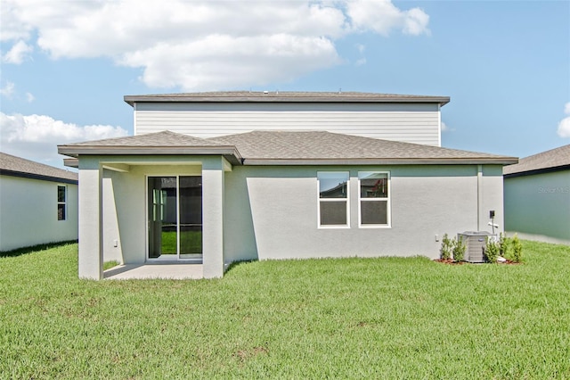 1740 Brekey Way, Zephyrhills, FL 33541 - rear view of property featuring a lawn and stucco siding