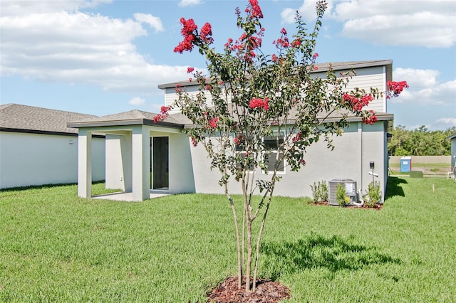 1740 Brekey Way, Zephyrhills, FL 33541 - rear view of property with a lawn and stucco siding