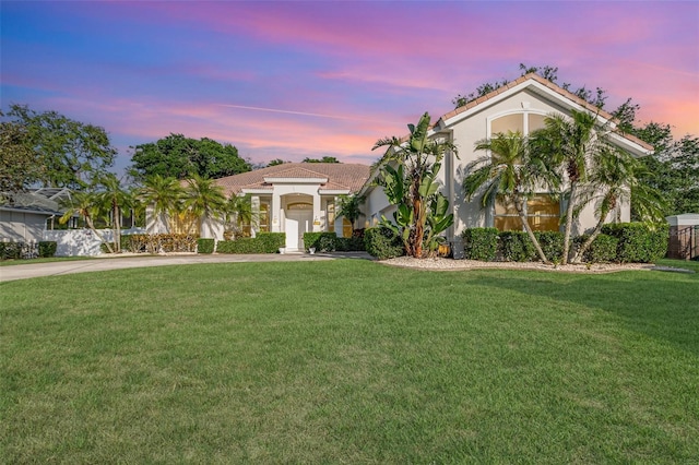 6121 Oxbow Bend Ln, Port Orange, FL 32128 - mediterranean / spanish house with driveway, a yard, and stucco siding