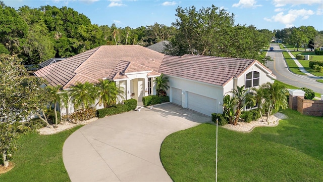 6121 Oxbow Bend Ln, Port Orange, FL 32128 - view of front of property featuring a tiled roof, an attached garage, stucco siding, and driveway