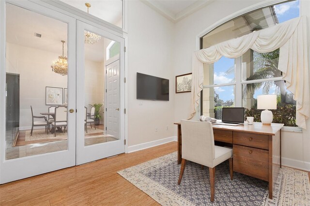 6121 Oxbow Bend Ln, Port Orange, FL 32128 - home office featuring a chandelier, wood finished floors, and baseboards